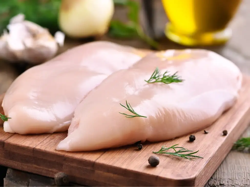 A photo of chicken on a cutting board