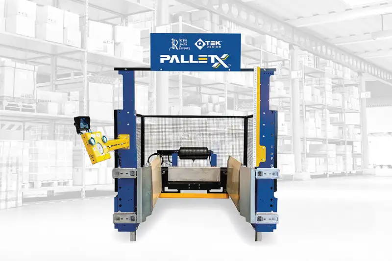 A photo of Rehrig Pacifics QTEK PALLETX machine with a blurry black and white warehouse in the background