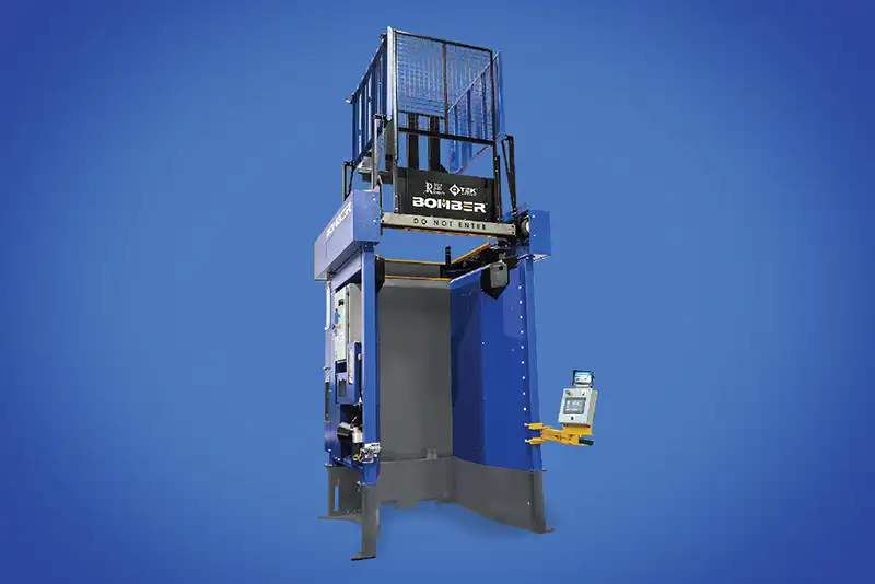 A photo of a blue Rehrig Pacific QTEK Bomber machine on a blue background